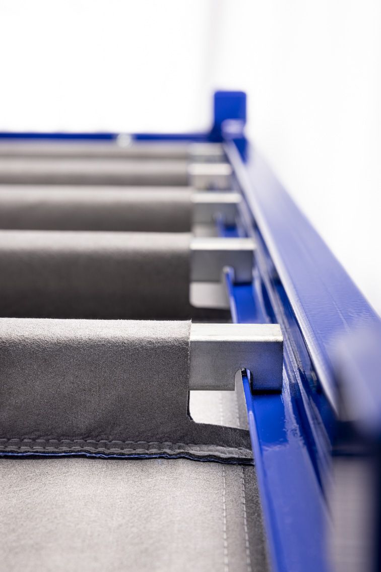 A close-up of a blue modular rack with textile inserts