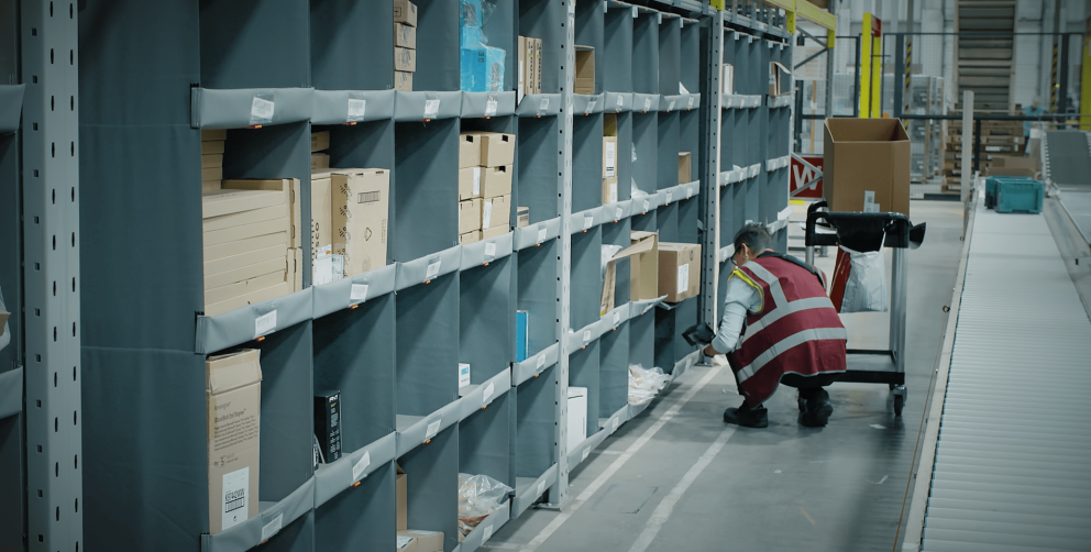 A person picking orders out of a storeganizer installation