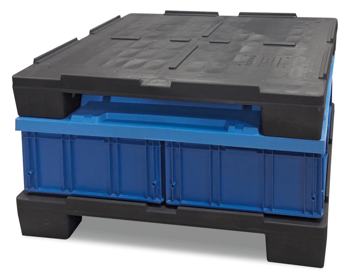 A stack of black plastic pallets with two blue containers in between.
