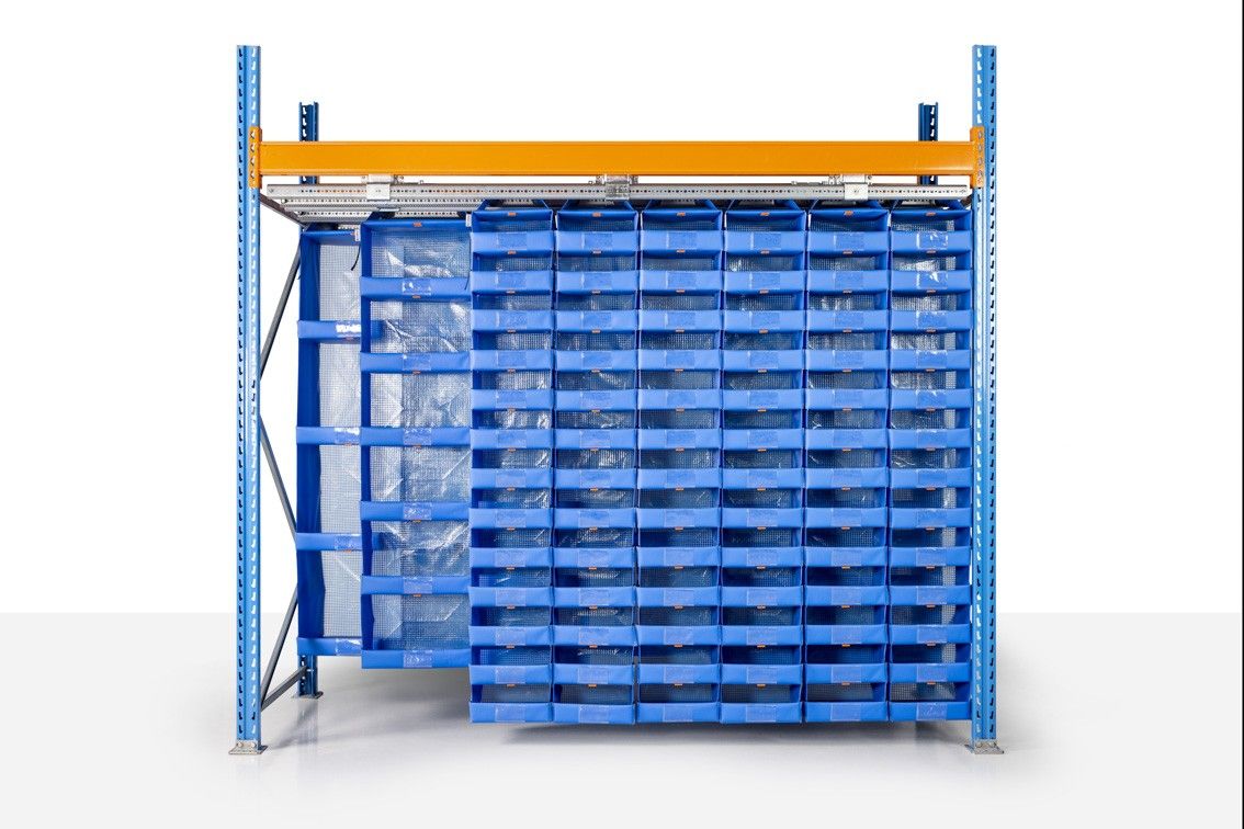 A storage rack with multiple blue bins arranged in a grid pattern, featuring a yellow overhead shelf and a white background.