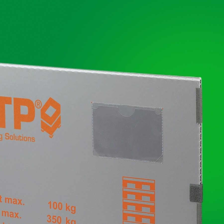 A close-up of a gray delivery box with orange text indicating weight limits and the logo of a packaging solutions company, set against a green background.