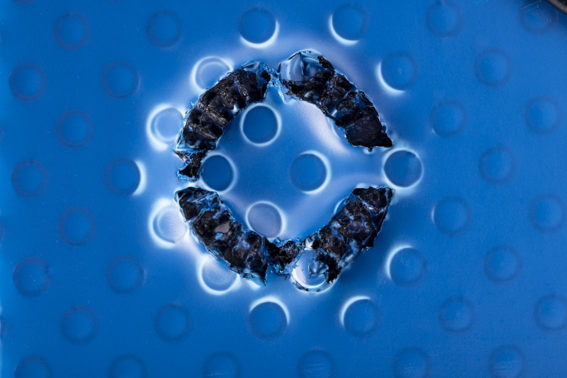 A detail shot of a blue conTeyor Ecobox with black details