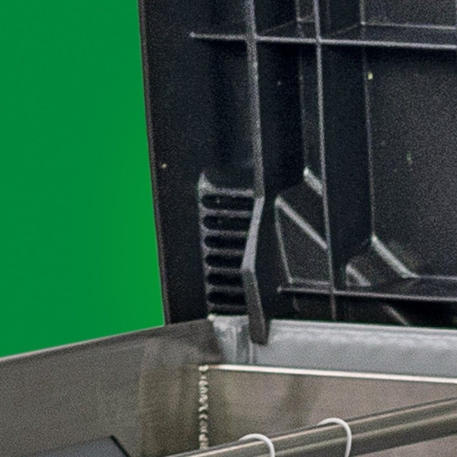 A close-up of the interior of a black storage container, showing the structure and design, with a green background.
