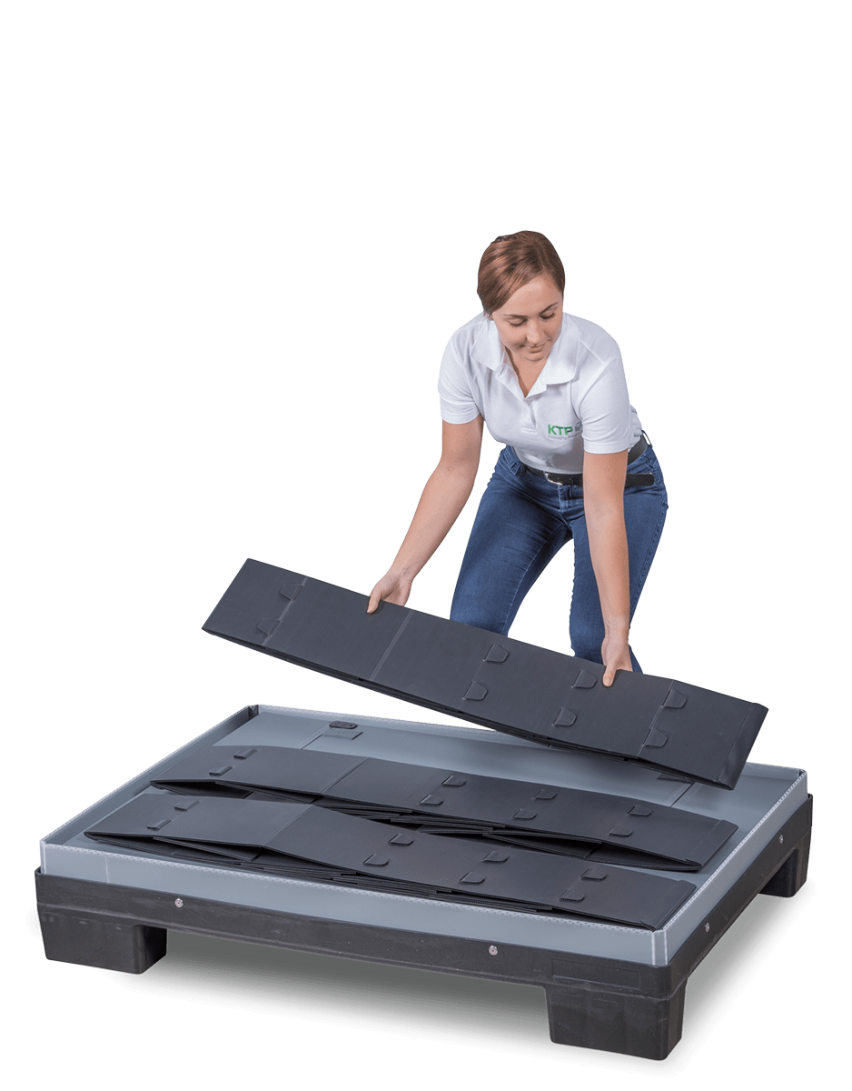 A woman assembling a modular platform system with grey and black components.