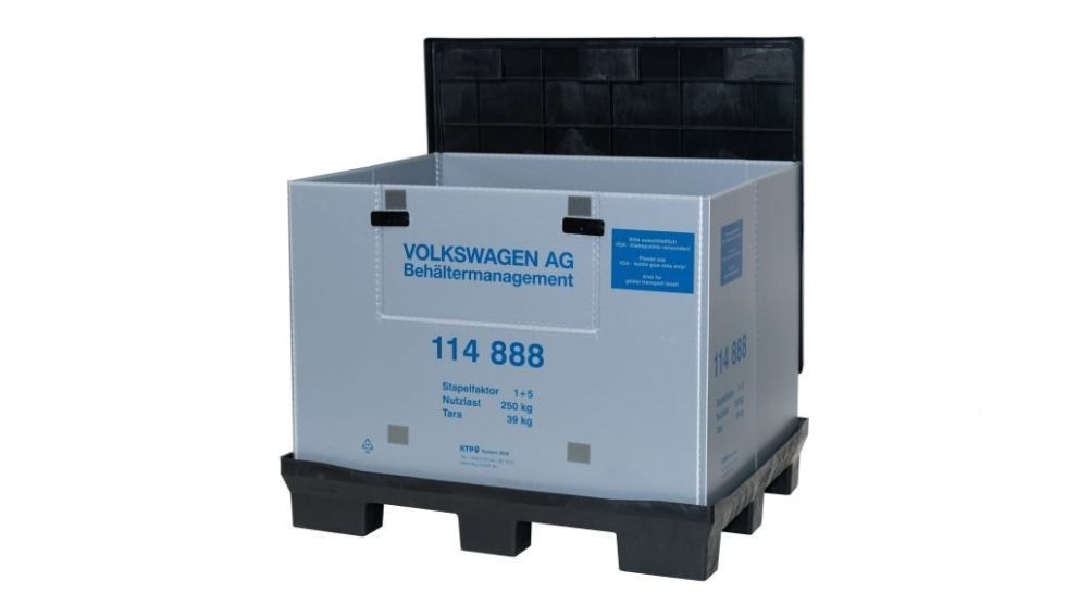A large gray plastic shipping container with a black lid, labeled with "VOLKSWAGEN AG Behältermanagement" and various weight specifications.