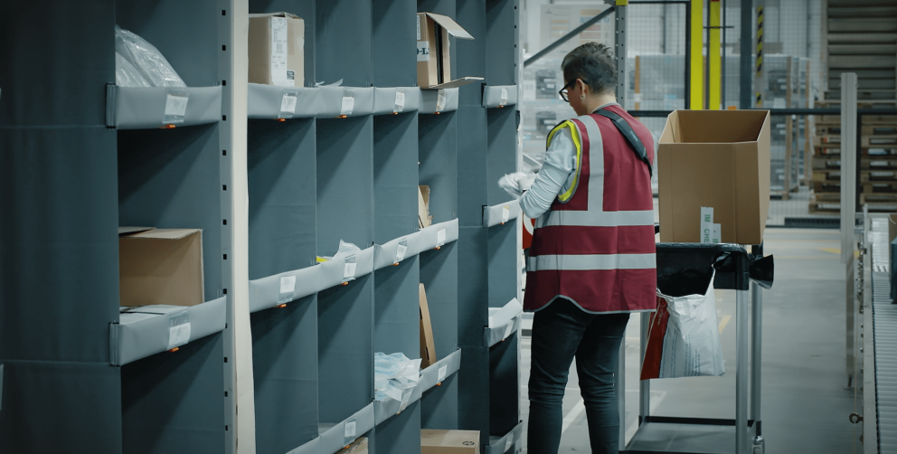 A person picking orders out of a storeganizer installation