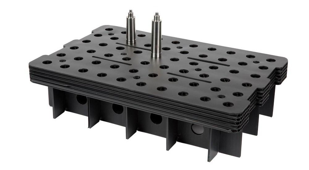 Black plastic tool rack with multiple holes and two metal pins on top.