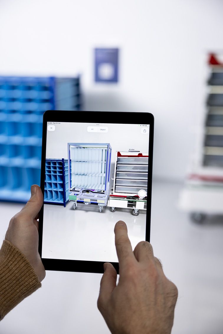 A person holding a tablet while operating the Nestimator software
