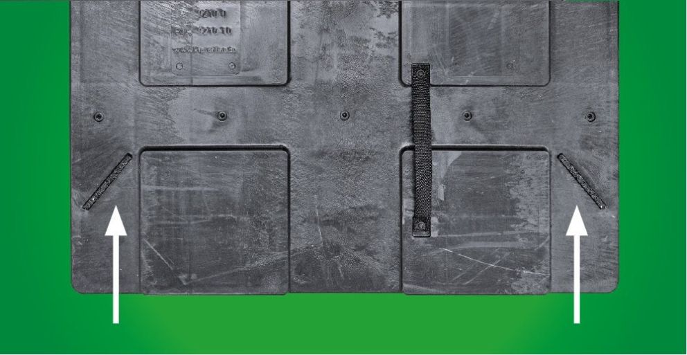 Black textured surface with sections, labels, and two arrows pointing up on a green background.