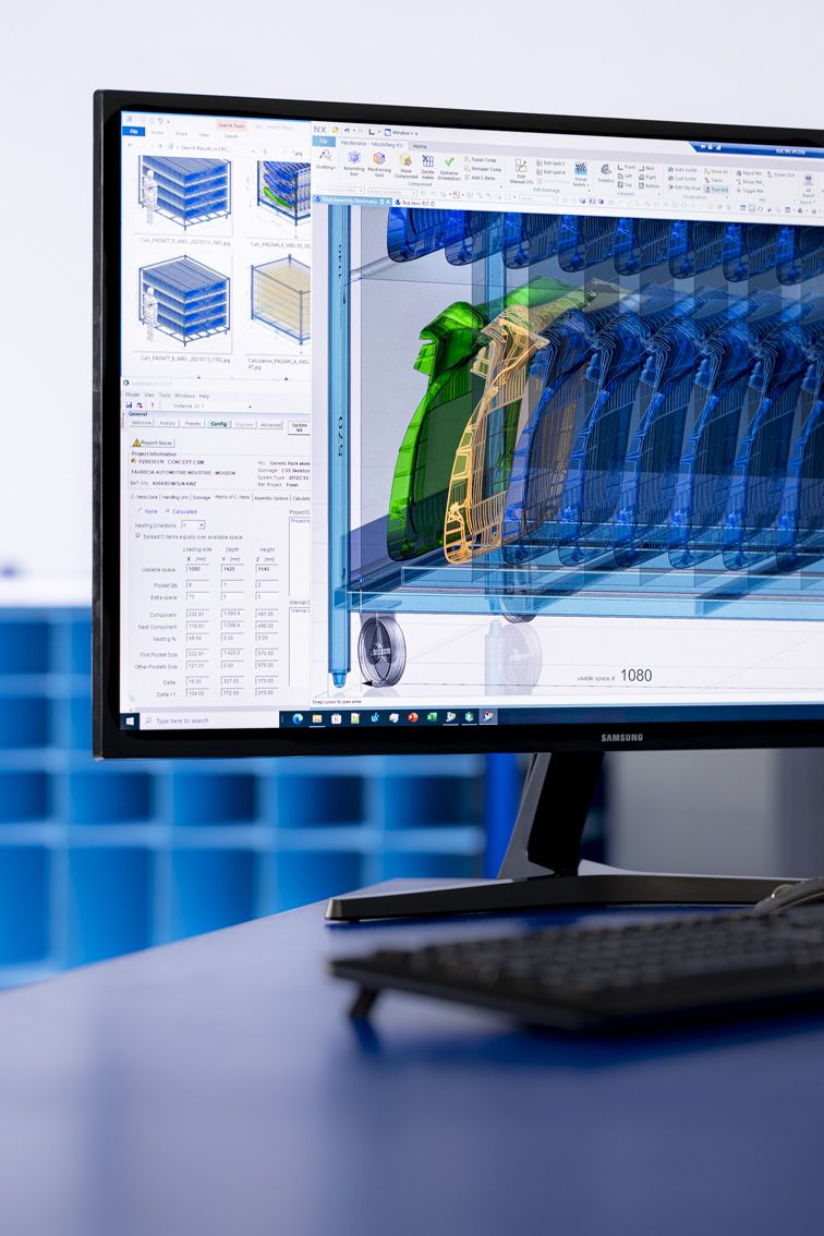 A computer sitting on a desk. On the screen is the Nestimator software developed by conTeyor