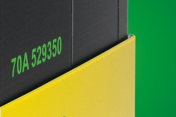 Close-up of a black box partially obscured by a yellow box, with green text reading "70A 529350." Background is a gradient of green.
