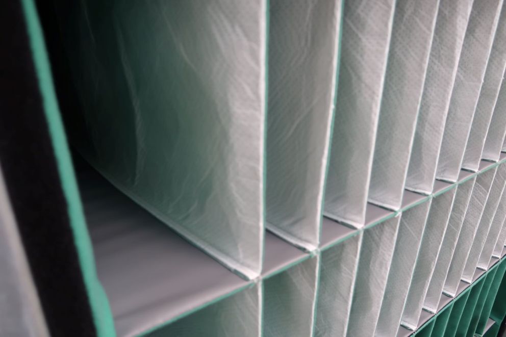 Close-up of vertical organizational file holders with a textured surface and a green trim.