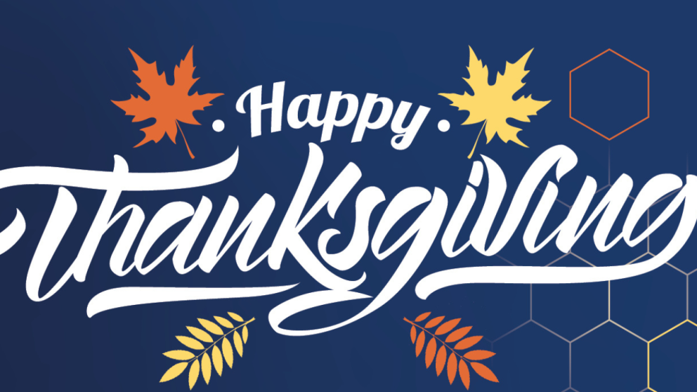 Text design featuring the phrase "Happy Thanksgiving," with colorful autumn leaves on a dark blue background.