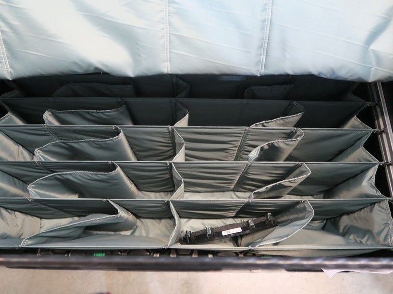 Storage container with multiple compartments for organization, featuring gray fabric dividers.