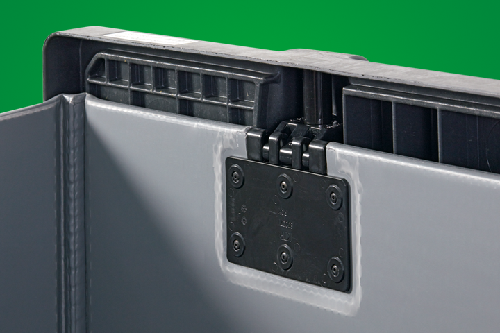 Close-up of a gray plastic storage container featuring a black hinge mechanism and structural details, set against a green background.