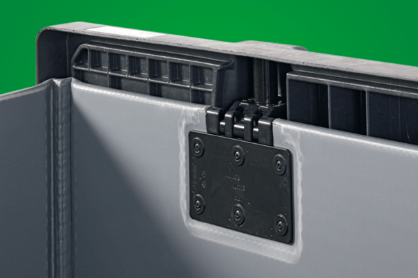 Close-up of a plastic container's hinge mechanism against a green background.