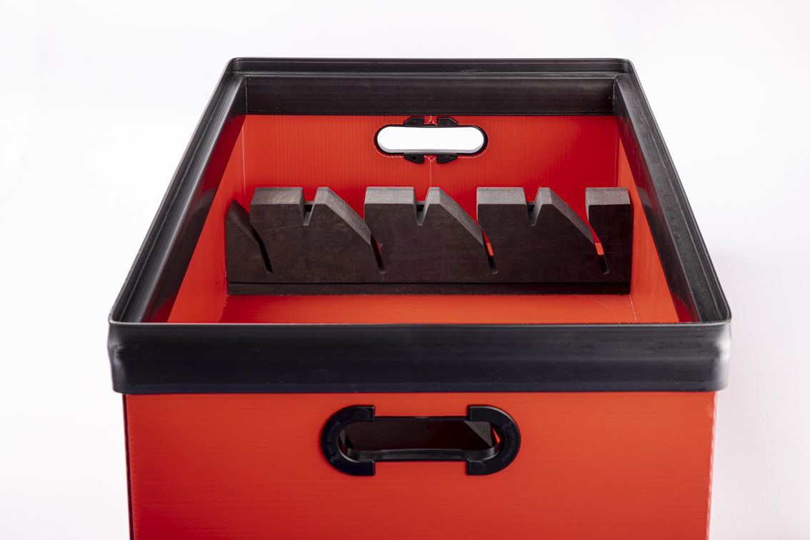 A detail shot of a red conTeyor Ecobox with black details