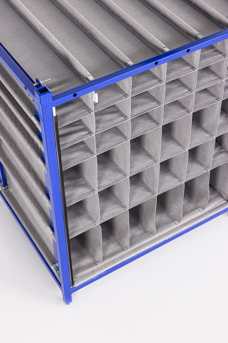 A close-up of a blue modular rack with textile inserts