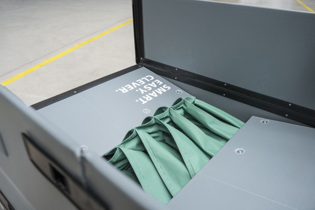 A storage box with a gray interior, displaying the text "SMART, EASY, CLEVER," and containing folded green fabric compartments.