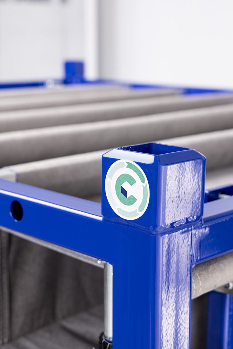 A close-up of a blue modular rack with textile inserts