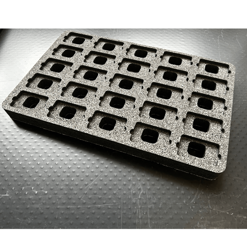 Black foam tray with multiple rectangular cutouts arranged in a grid pattern.