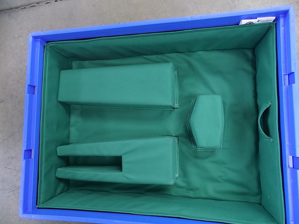 A blue plastic container with a green cushioned interior featuring two tall rectangular sections and one small hexagonal section.
