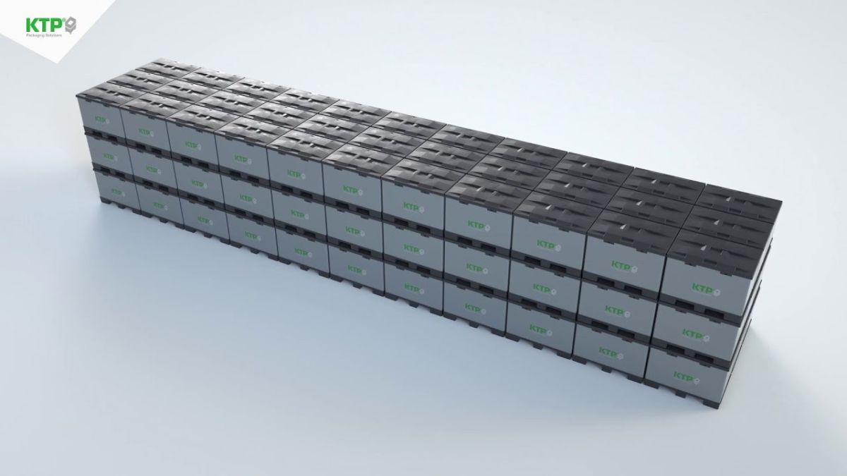 A stack of gray packaging boxes with the letters "KTP" printed in green, arranged in rows.