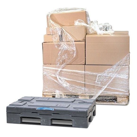 Stack of cardboard boxes secured with plastic wrap on a wooden pallet, with a black plastic pallet in the foreground.