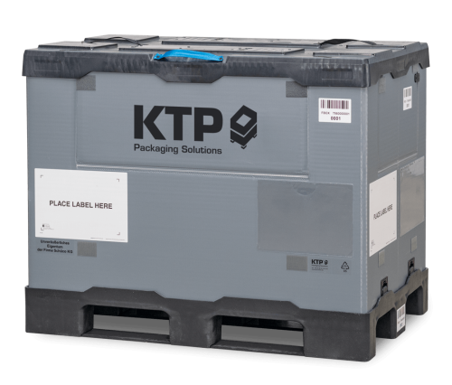 Gray shipping crate with the label "KTP Packaging Solutions," featuring a designated area labeled "PLACE LABEL HERE."