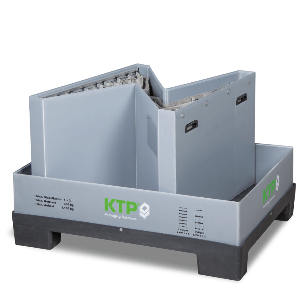 Gray packaging container with two removable compartments on a black pallet, labeled with "KTP Packaging Solutions."