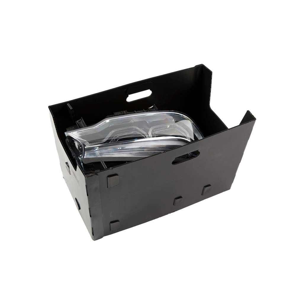 A black storage box containing car headlights.