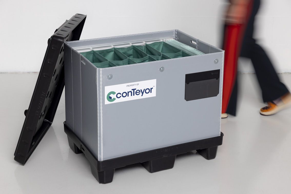 Ecopack KIT with an open lid and a person walking behind it